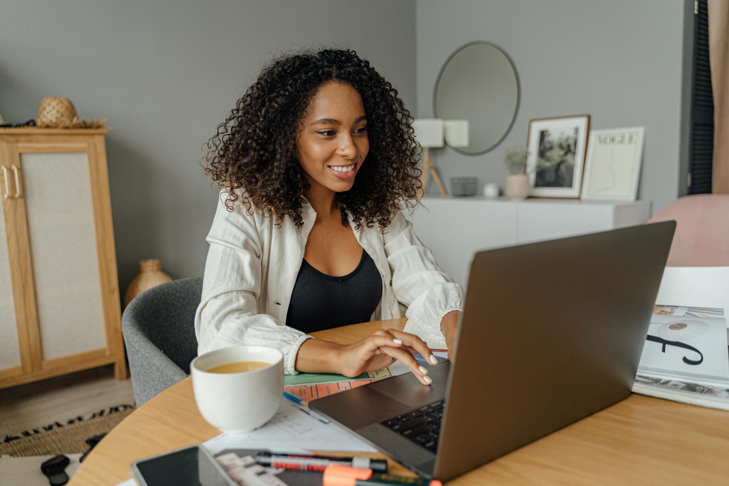 A recent graduate using a laptop to look for direct sales jobs