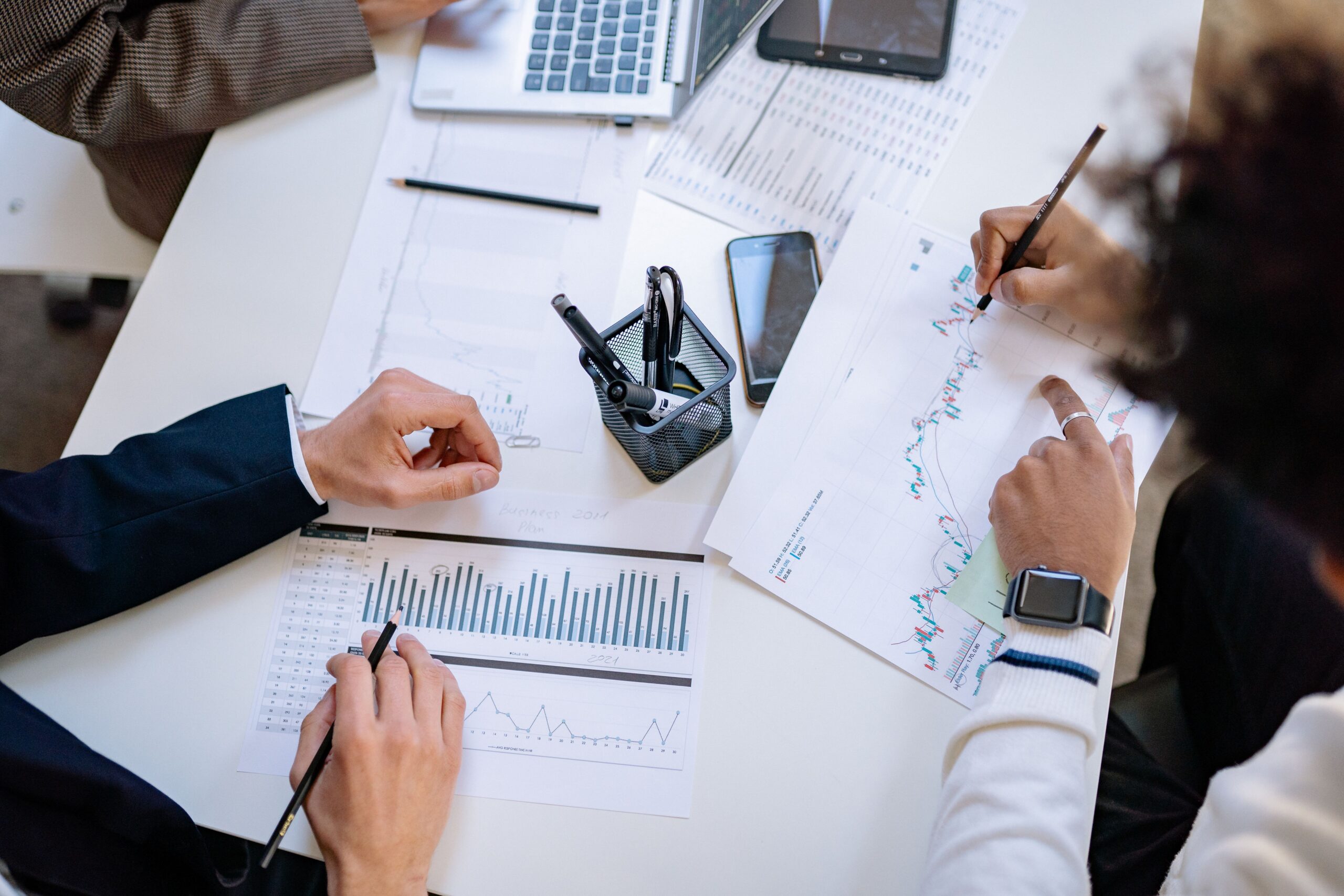 Business team analyzing financial charts and graphs.